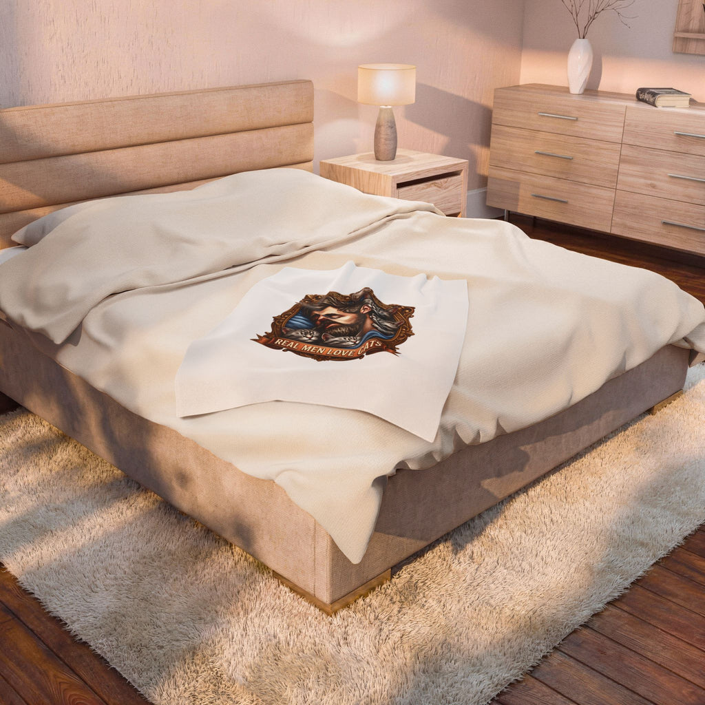 Real Men Love Cats velveteen plush throw, 30 by 40 inches, folded at the foot of a bed.