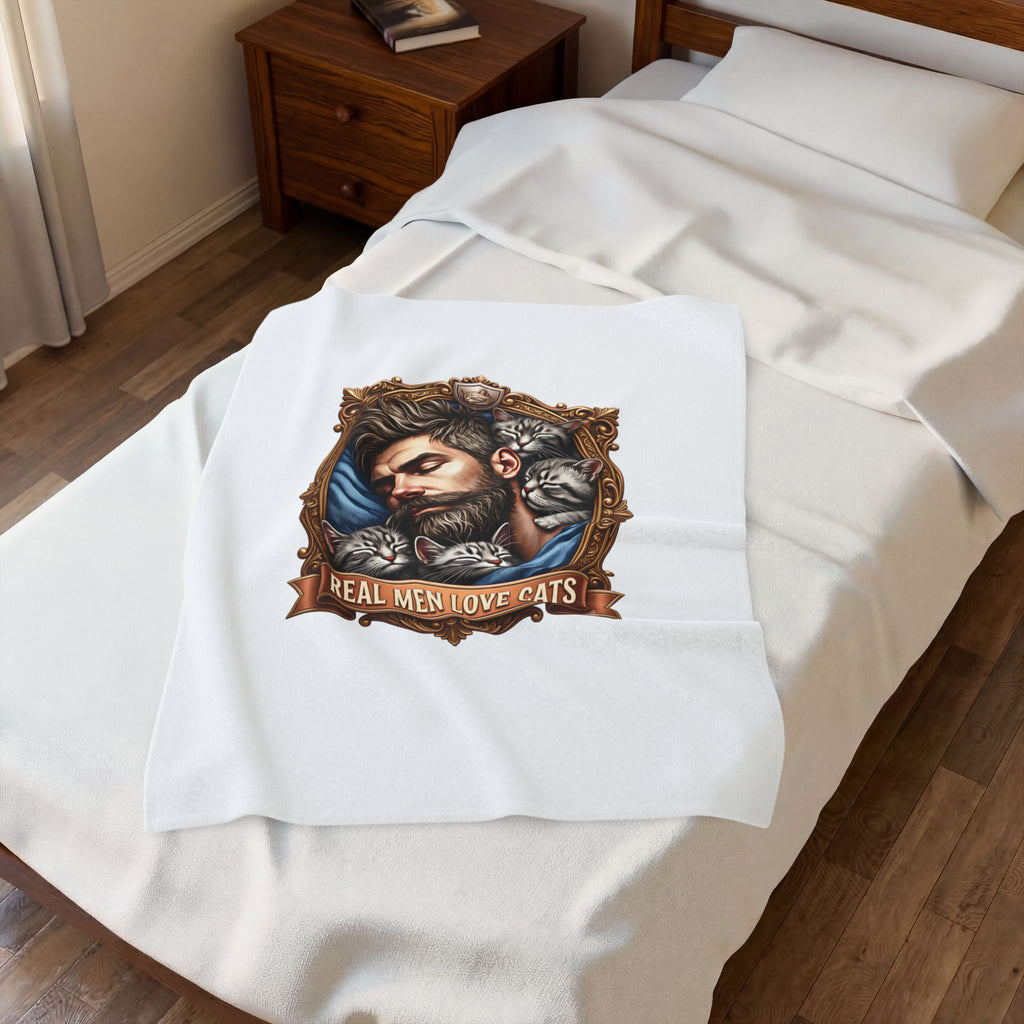 Real Men Love Cats velveteen plush throw, 30 by 40 inches, folded on the corner of a bed.